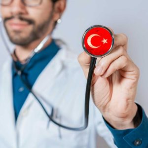 Doctor holding stethoscope with Turkish flag symbolizing medical tourism and healthcare excellence in Turkey